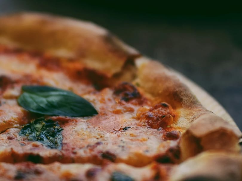 Close up of pizzas on table