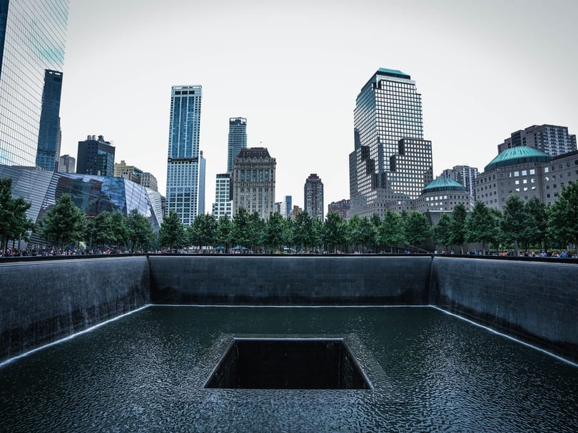 Water cascading down the sides of one of the 9/11 Memorial reflecting pools