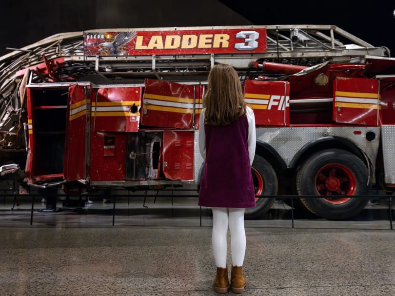 Girl looking at Ladder 3 exhibit in the 9/11 Museum