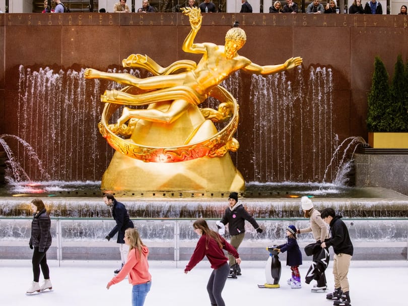 People ice skating near the Prometheus Statue in Rockefeller Plaza